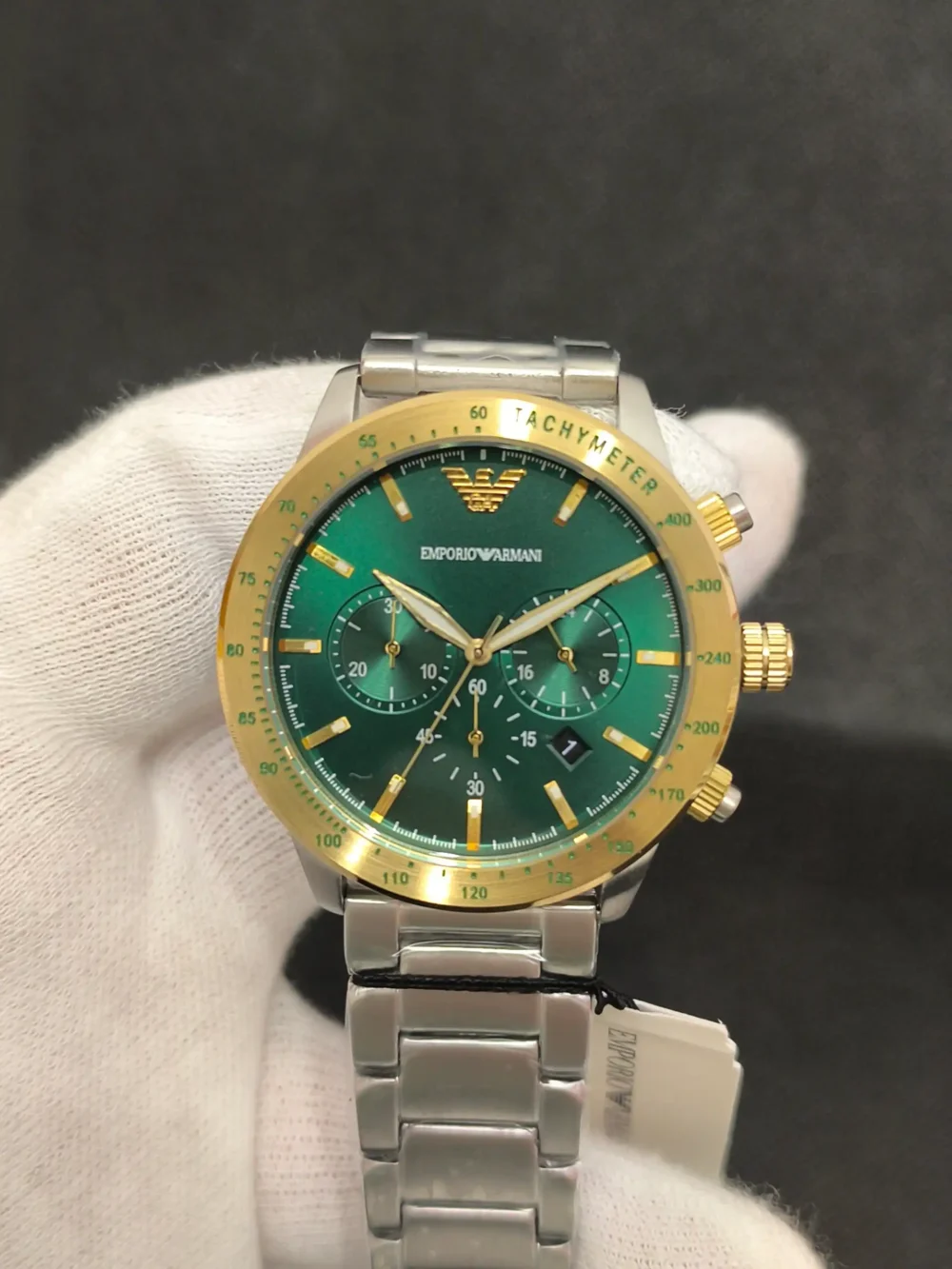 Reloj Emporio Armani AR11454 con esfera verde, bisel dorado y correa de acero inoxidable. Cronógrafo con taquímetro y resistencia al agua de 5 ATM.