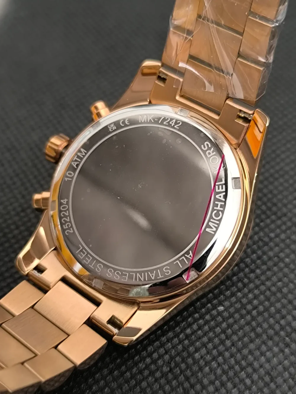 Reloj Michael Kors MK7242 Lexington con caja en oro rosa, cronógrafo y correa de acero inoxidable y resistencia al agua de 10 ATM.