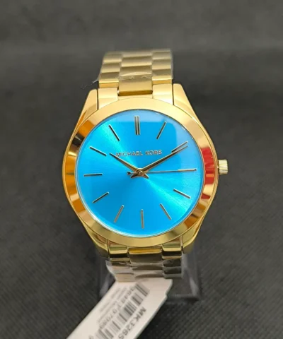 Reloj Michael Kors Slim Runway MK3265 con caja dorada y esfera azul brillante. Diseño minimalista, correa de acero inoxidable y resistencia al agua 5 ATM.